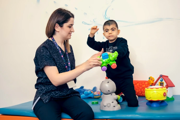 a woman playing with a child on a table